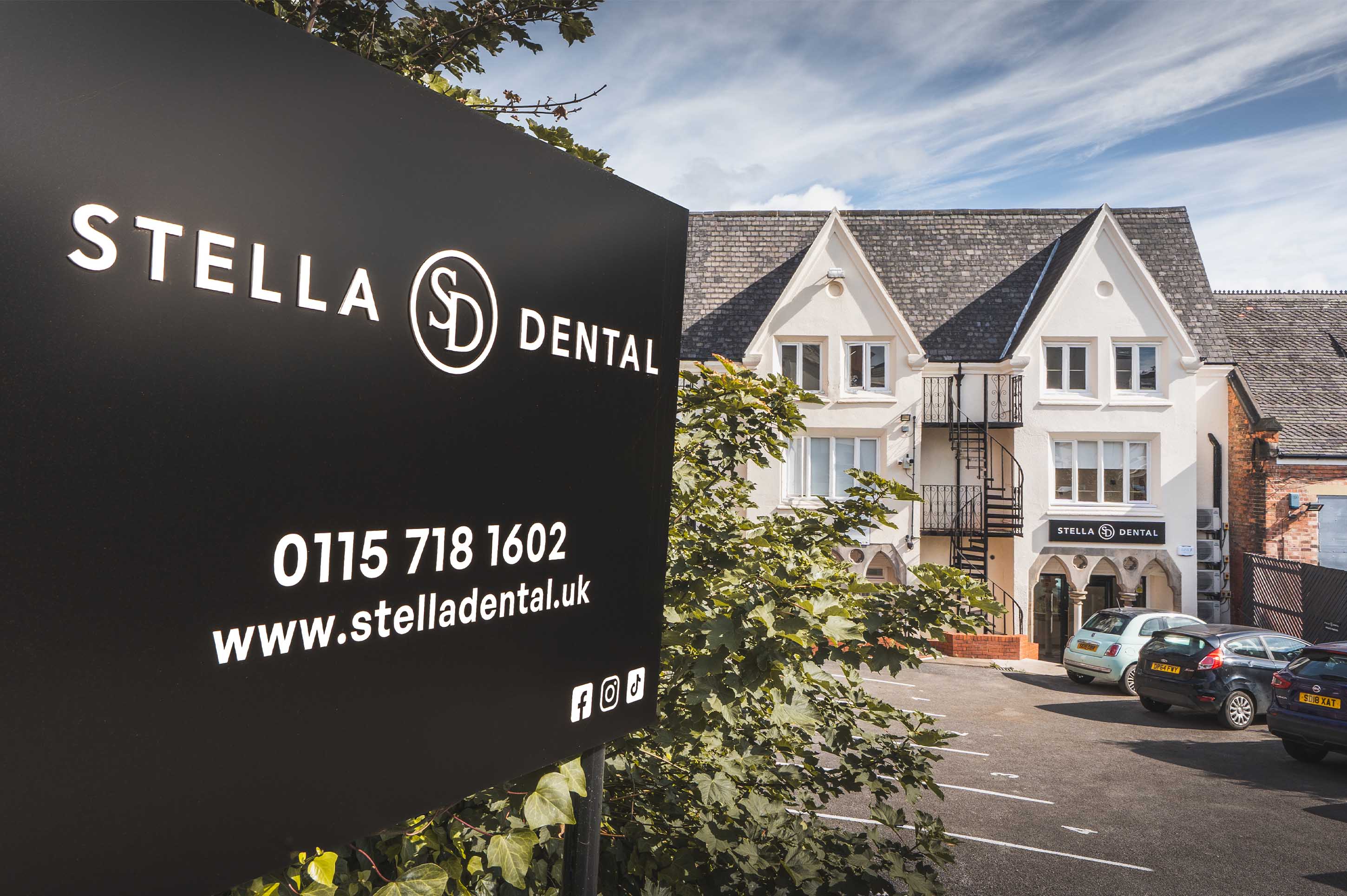 Stella Dental sign in front of the Stella Dental building with a clear sky