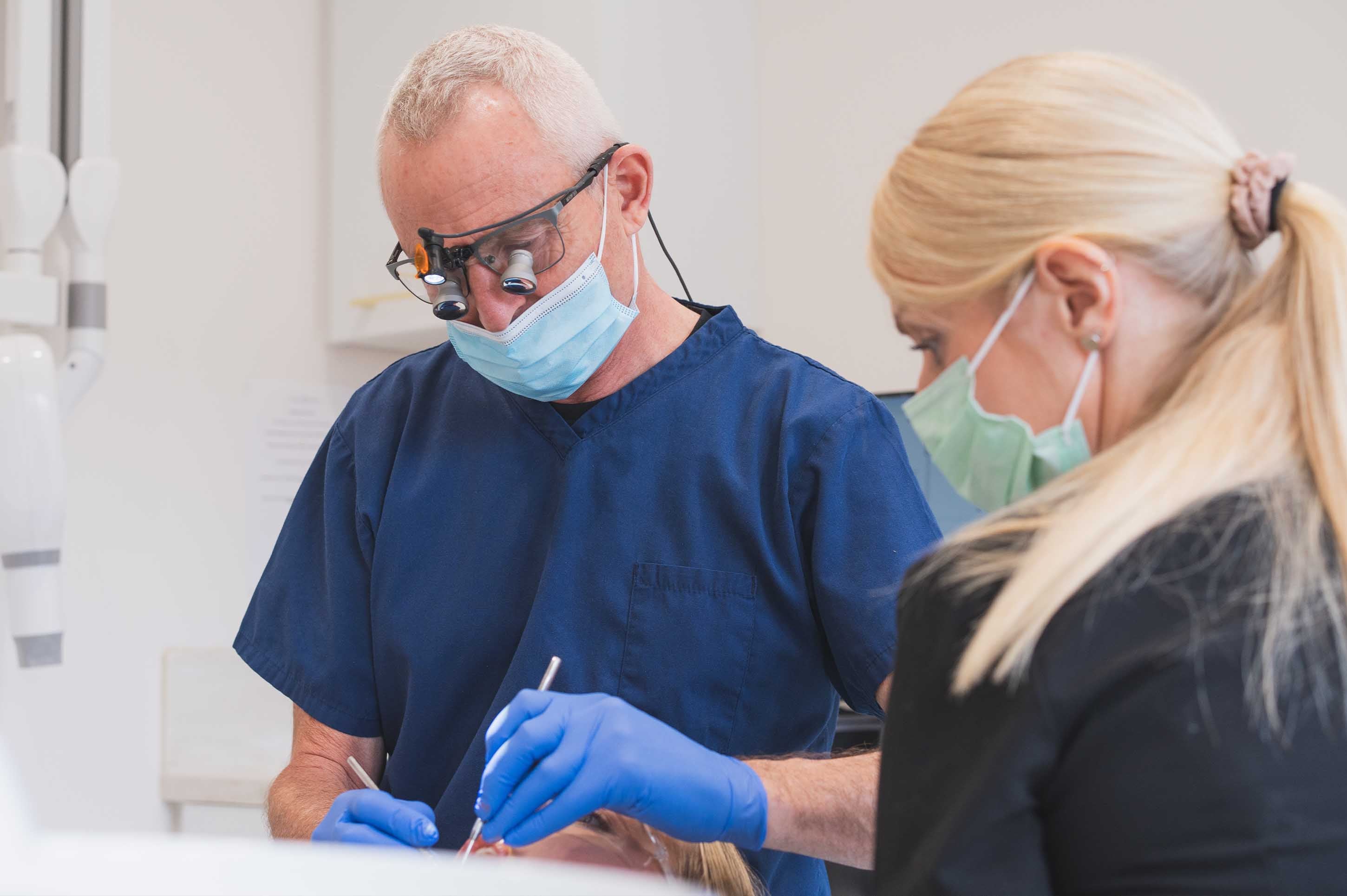 Dentist and dental assistant working together in a dental office.