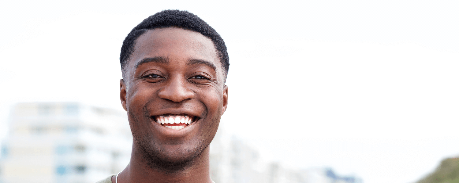 man smiling wearing Invisalign clear aligners