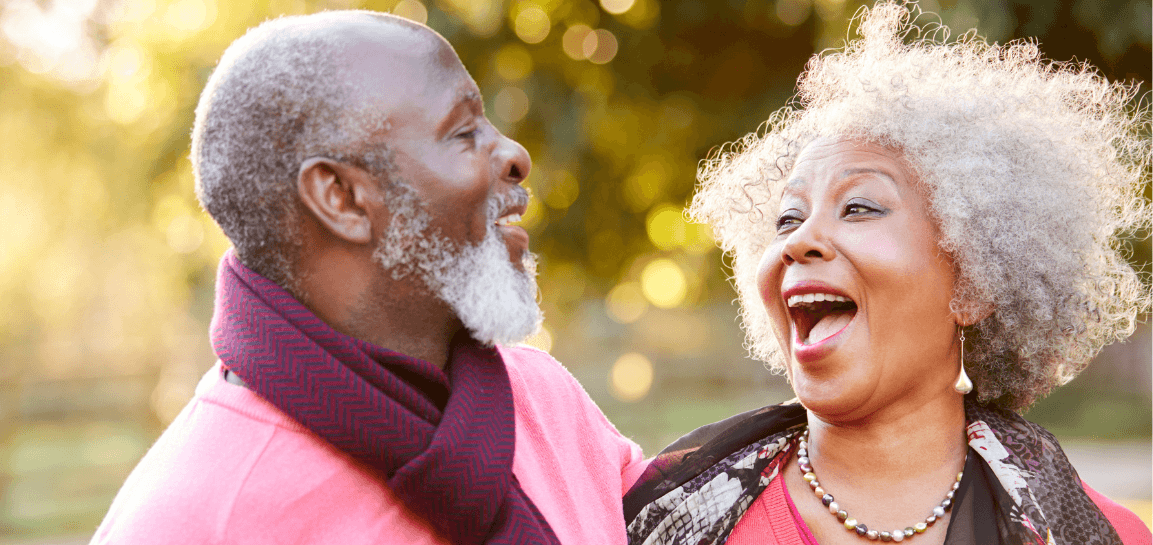 older couple with dental implants smiling