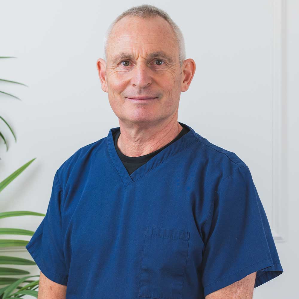 Dr Anthony Dash wearing a blue scrub top 