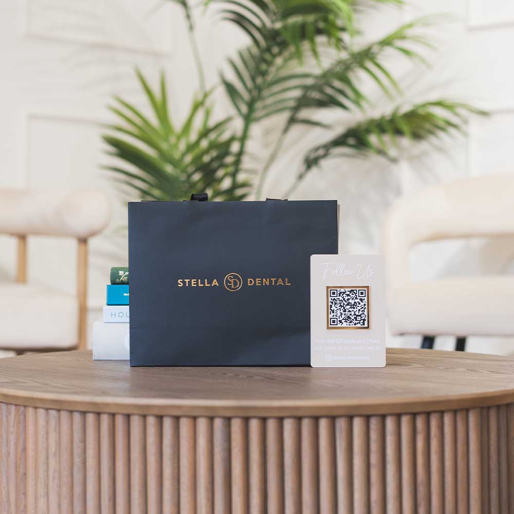 Stella Dental packaging on a table with a plant in the background
