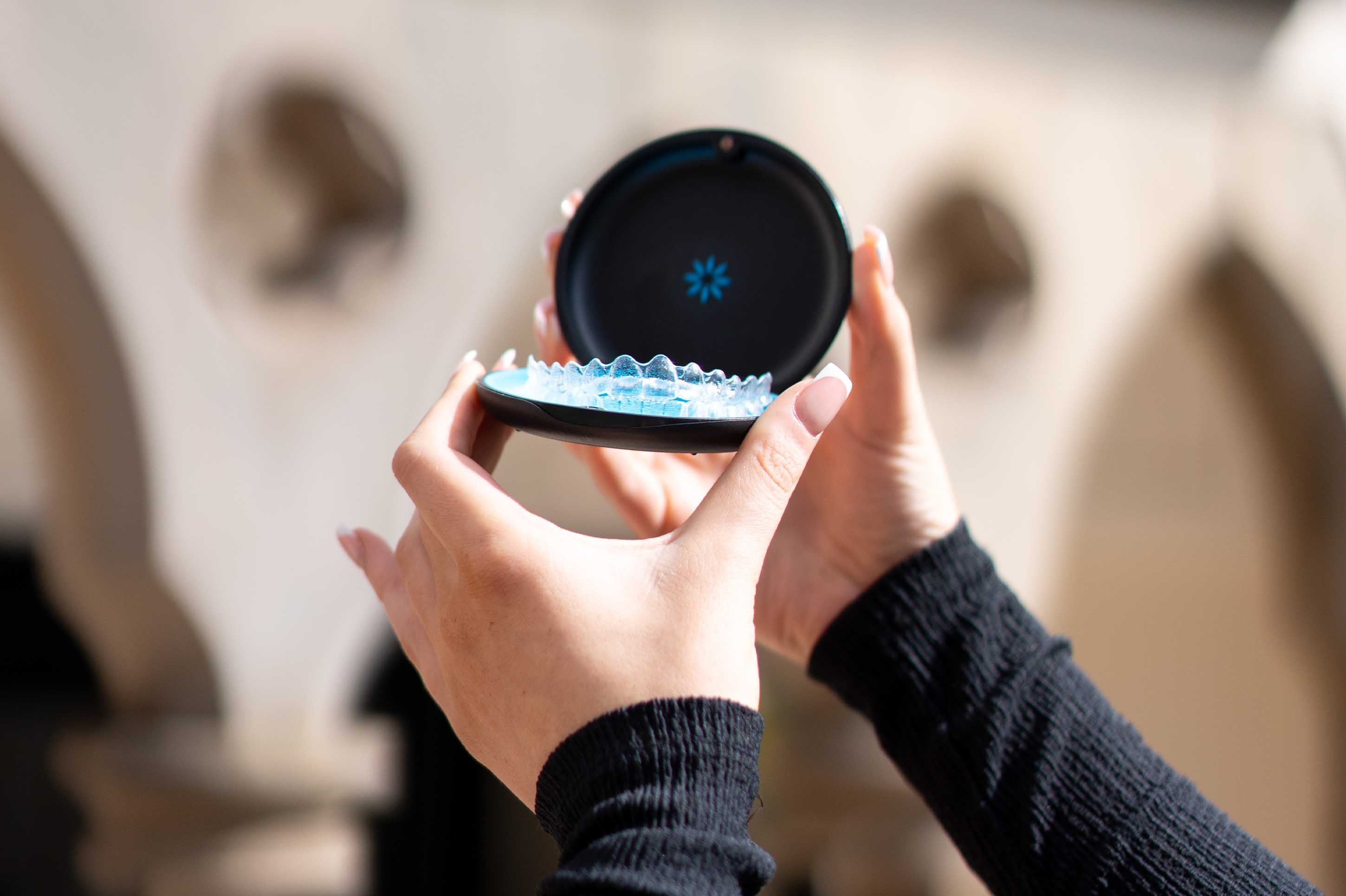 Person holding Invisalign aligners in case