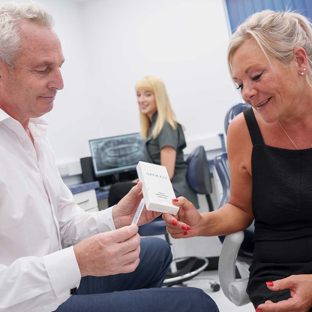 Dr Anthony Dash showing a product to a patient at Stella Dental