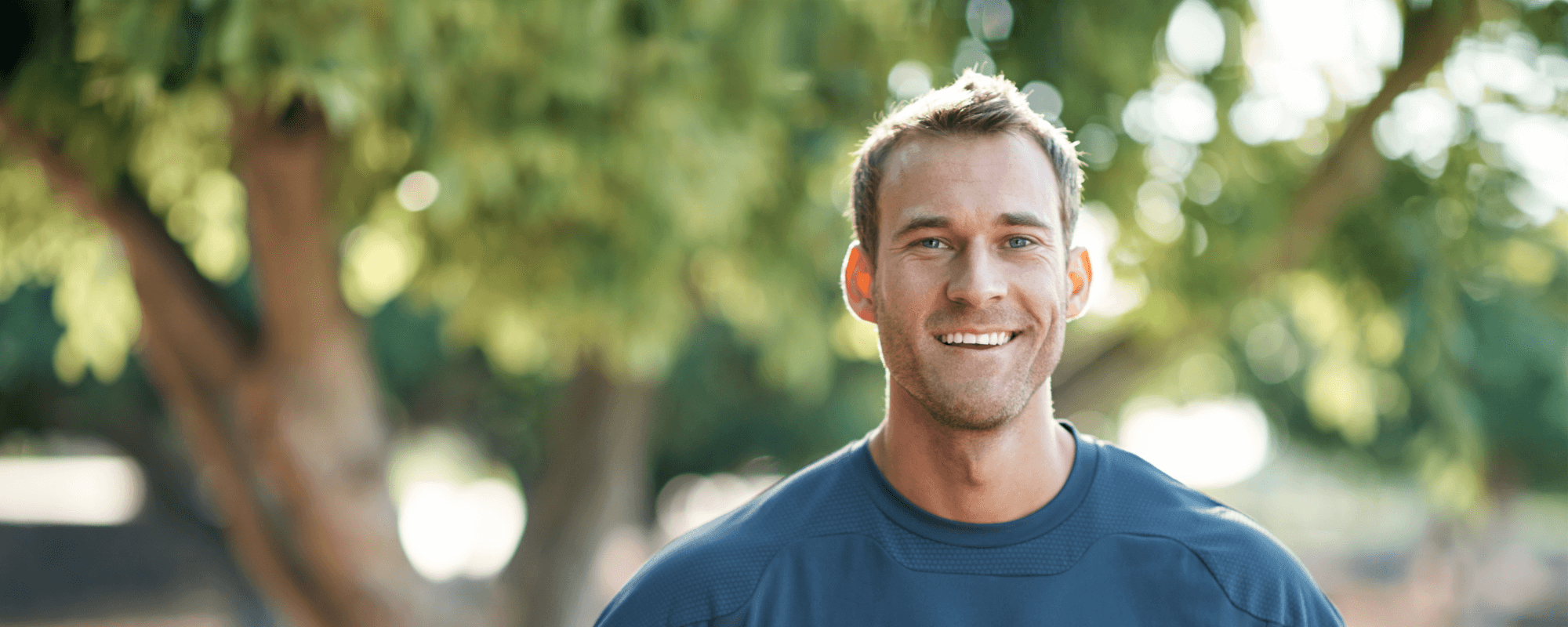 man smiling after dental implant recovery